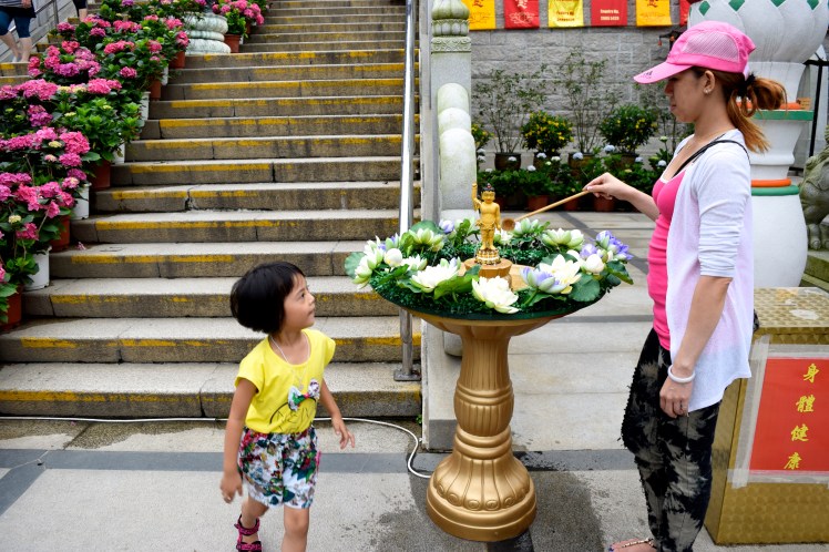 Mother and daughter bathing the Buddha.